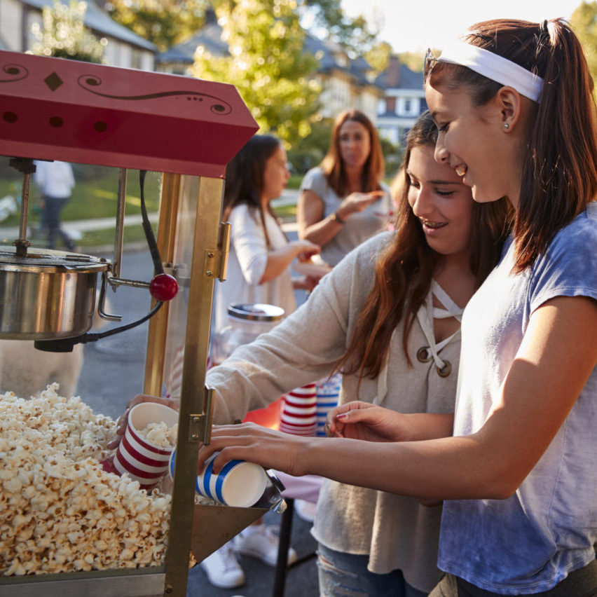 Girls serve themselves popcorn at neighbourhood block party